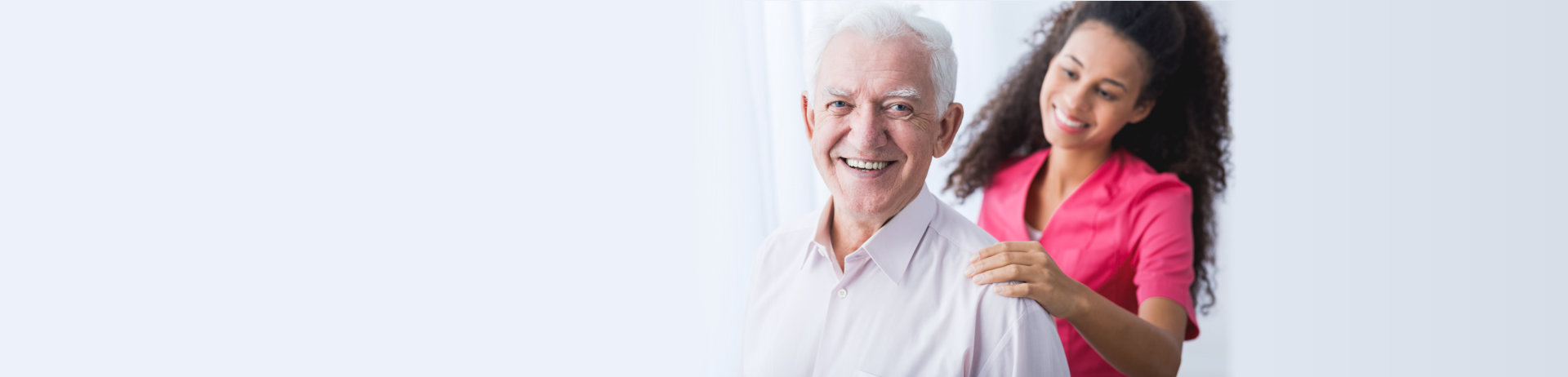 senior man smiling at his caregiver